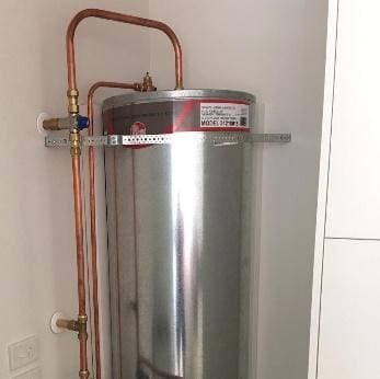 A sleek, modern hot water cylinder installed in a home.
